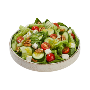 Fresh salad with lettuce, cherry tomatoes, cucumbers, feta cheese, and walnuts in a ceramic bowl.